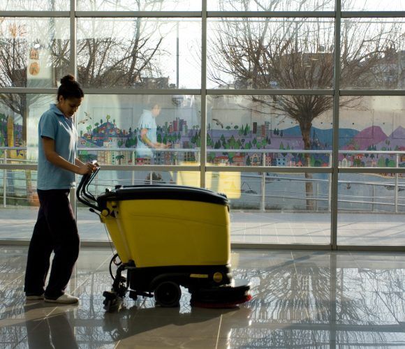A Man worker cleaning the floor with scrubber machine. image. High quality photo